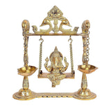 Brass idol of Ganesha on a swing with two hanging lamp bowls, seated in center