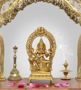 Brass Saraswati goddess idol with arched halo, four arms, ornate pedestal