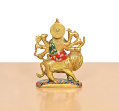Back view of brass Durga Maa on lion, green and red garments with painted accents
