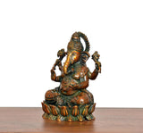 Lord Ganesha brass idol, side view seated with four arms, textured ornaments and crown