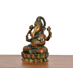 Lord Ganesha brass idol, side view seated with four arms, textured ornaments and crown