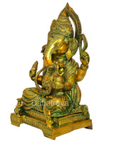 Brass Ganesha statue from side angle, multi-color finish, seated with four arms