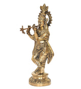 Brass Krishna idol side view, holding a cross-shaped flute, on round base