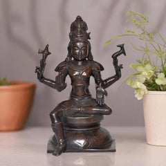 Intricately detailed Lord Shiva statue, seated in prayer with raised trident arms, dark brass finish
