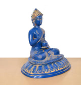 Blue brass Buddha statue seated on round base, angled view, gold ornamentation