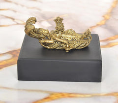 Gold tone Vishnu reclining on Sheshanaag, detailed base, 1-inch height