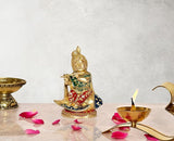 Brass Krishna statue seated on shank, multicolor detailing, front view, 8 inch