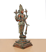 Brass Lord Vishnu idol from side view, four arms raised, ornate draped ornaments