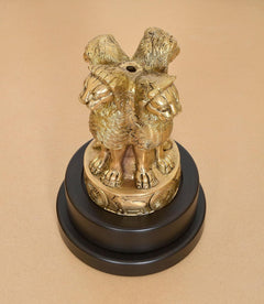 Brass Ashoka figurine with animal-like motif on revolving dark base plaque