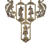 Close-up of brass Dashavatara figures in two arched frames with curled side scrolls