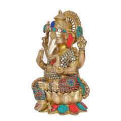 Three-quarter brass Ganesha statue with patterned clothing, jeweled crown, ornate base