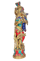 Krishna idol brass figurine from side angle, jeweled crown and painted blue robe