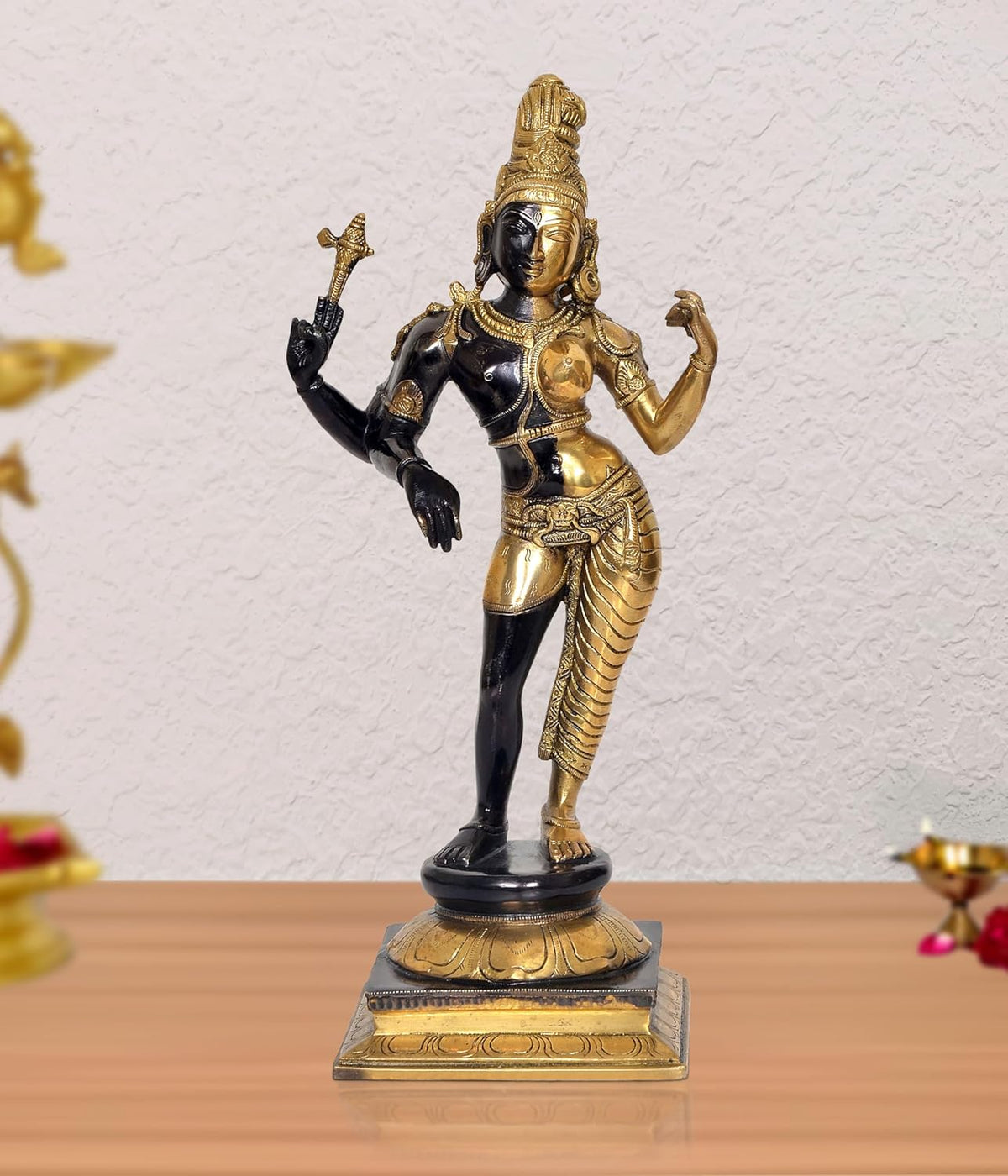 Brass Ardhanrishvara Shiva-Parvati statue with raised hands, black and gold finish, on base