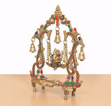 Brass Ganesha playing swing idol in multicolor, close side view with hanging bell accents