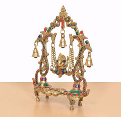 Brass Ganesha playing swing idol in multicolor, close side view with hanging bell accents