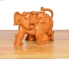 Angled view wooden elephant showpiece with carved details and mini elephant figures, orange-brown