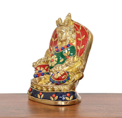 Brass Kubera statue side view, red back halo, gold hands, blue bead accents