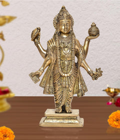 Brass Dhanvantri statue with four raised arms, gold-tone detailing, on pedestal base.