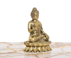 Brass seated Buddha idol, Abhaya mudra hand raised, detailed robe, angled view