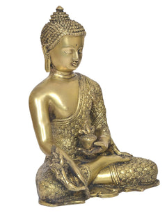 Brass meditating Buddha statue, three-quarter view, detailed headgear and robe patterns
