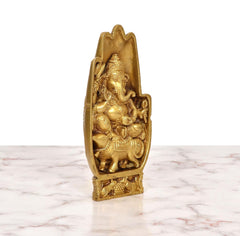 Golden brass Ganesha idol angled side view, seated blessing pose with mouse and base carvings.