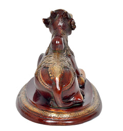 Reverse view Nandi bull statue, gold-toned head, red back and patterned seat