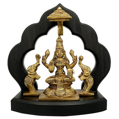 Brass Maha Lakshmi idol with elephant attendants on dark wooden temple base, 7.5 in