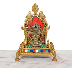 Brass pooja chowki with Ganesha idol, red tiled backdrop, gold arch, multicolor trim
