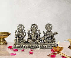 Brass Ganesha, Lakshmi and Saraswati showpiece on ornate pedestal, 3 inch