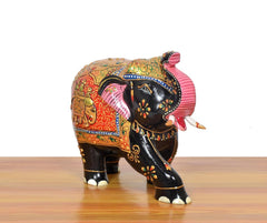 Wooden elephant showpiece from behind, black body with multicolor patterned back