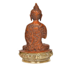 Brass Buddha idol rear view, detailed patterned robe, seated on ornate round pedestal