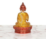 Brass Buddha idol rear angle, ornate golden robe details, seated on red-gold lotus base