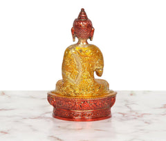 Brass Buddha idol rear angle, ornate golden robe details, seated on red-gold lotus base