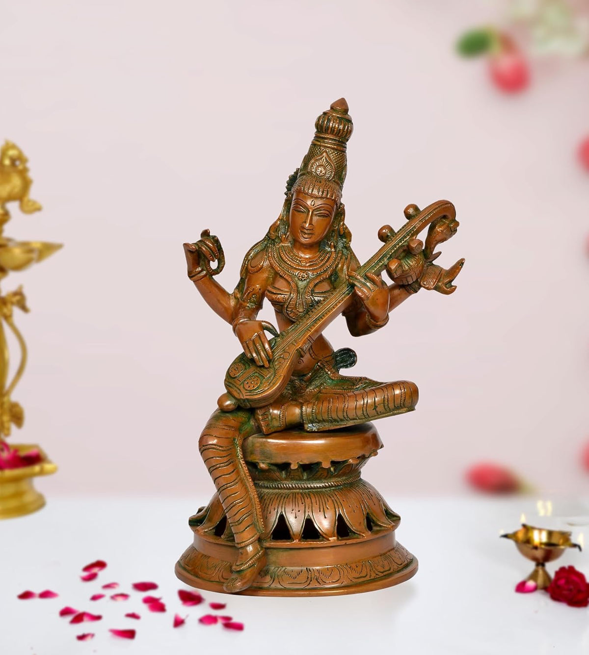 Brass Maa Saraswati statue with veena, seated on tiered base, handcrafted details