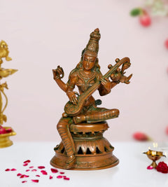 Brass Maa Saraswati statue with veena, seated on tiered base, handcrafted details