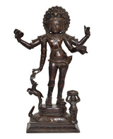 Brass-toned Bhikshatana Shiva idol with outstretched arms and small attendant figure at base
