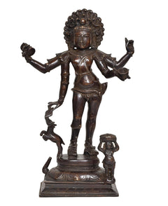 Brass-toned Bhikshatana Shiva idol with outstretched arms and small attendant figure at base