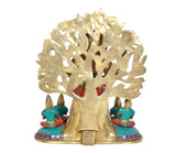 Rear view of brass Dakshinamurti Shiva statue, carved arch halo