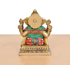 Brass Ganesh murti back view, teal belt and red jewel panels on gold body