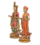 Resin swami idol set, left and right side profiles with crowns, draped robes, floral base