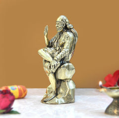 Brass Shirdi Sai Baba statue, angled view, one hand raised in blessing