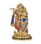 Radha Krishna brass idol standing with detailed red, blue, and green jeweled clothing