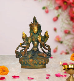 Brass Tara Devi statue of Green Tara, seated in lotus pose with multiple arms