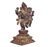 Brass dancing Ganesha and Lakshmi idol, rear three-quarter view on patterned base