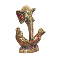 Brass Ganesha idol side view with red-green enamel ears and jeweled palm