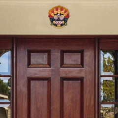 Nazar Battu wall hanging mounted high on door, small demon face protective emblem