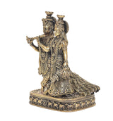 Brass Radha Krishna idol statue from side view, Krishna playing flute on ornate base