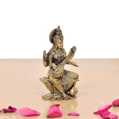 Maa Saraswati brass statue seated on lotus, veena across lap, one hand raised
