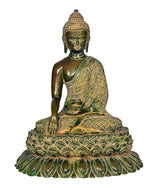 Brass Buddha statue on lotus pedestal, seated meditation pose, gold-and-green relief