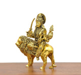 Durga Maa brass idol on lion, side view with raised trident and drum